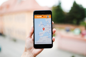 Human hand holding mobile phone with map gps navigation on screen