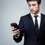 Young businessman looking at smartphone