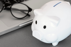 Piggy bank next to laptop