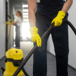 Front view man cleaning indoors